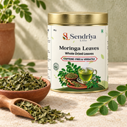Whole dried moringa leaves in Sendriya Life tin with ingredient styling