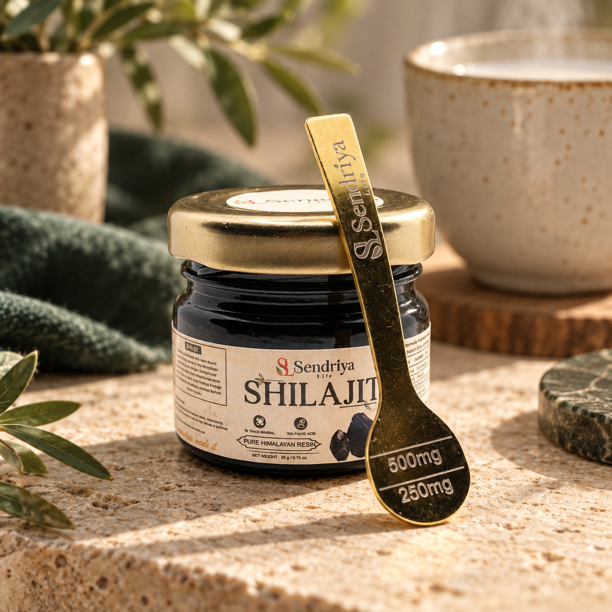 Styled photographic view of Shilajit jar and branded spoon marked 250 mg and 500 mg